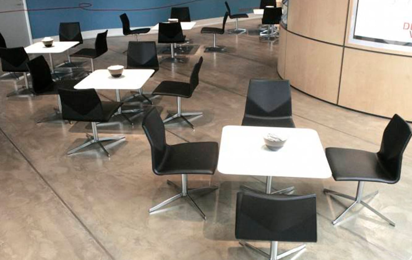 A group of black chairs and tables in a room.