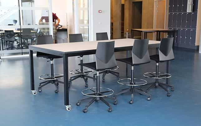 A conference table and office desk chairs in a conference room.