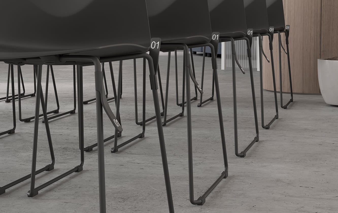 A row of black chairs in a conference room.