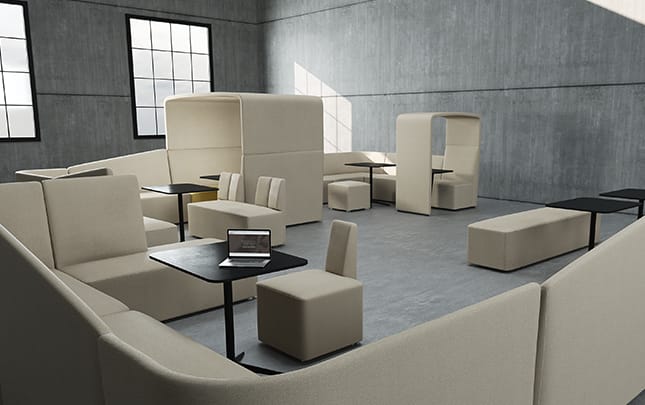 A modern office with office work booths, couches, tables and chairs.