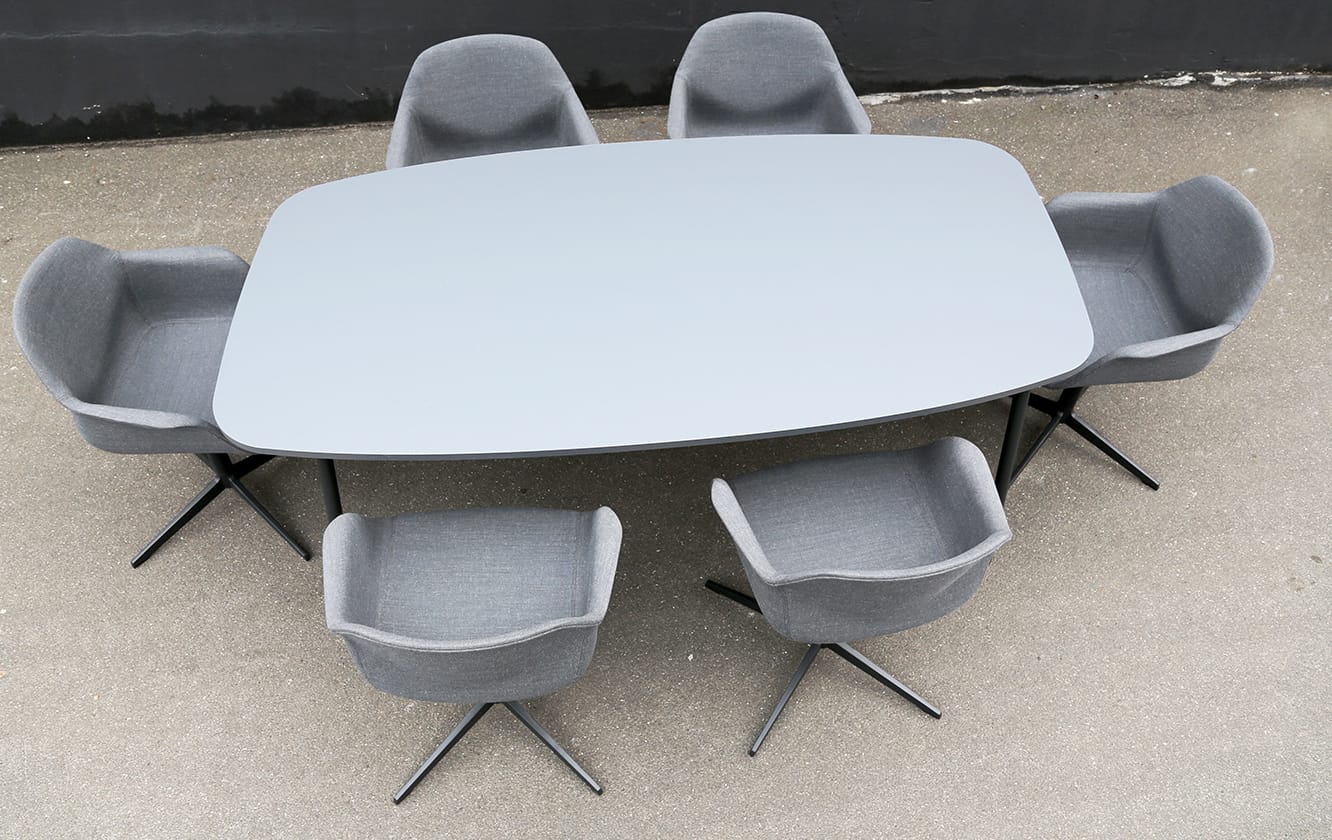 A grey dining table with six grey chairs.