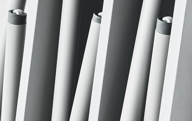 A close up of a row of metal table legs