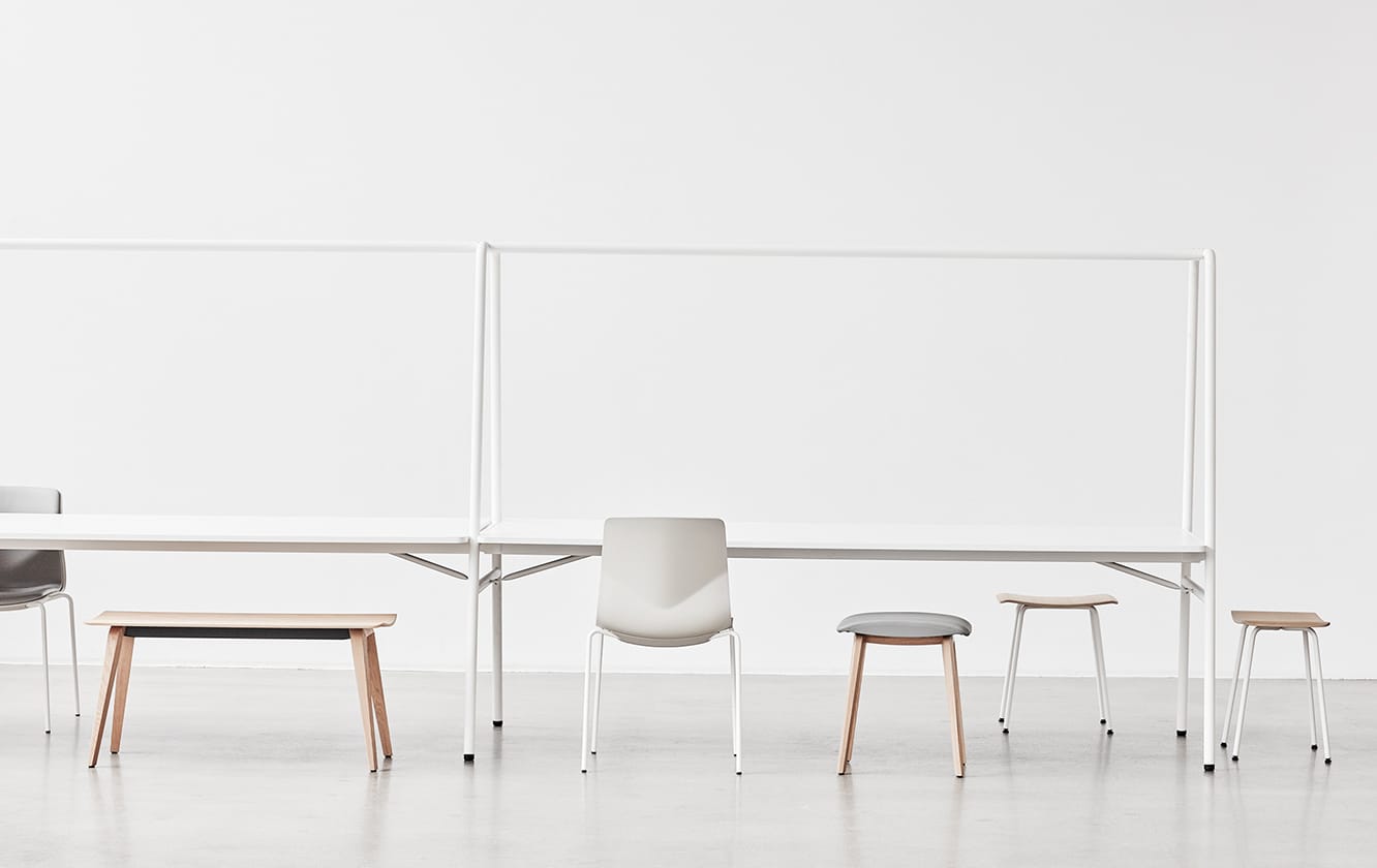 A group of chairs and tables in a white room.