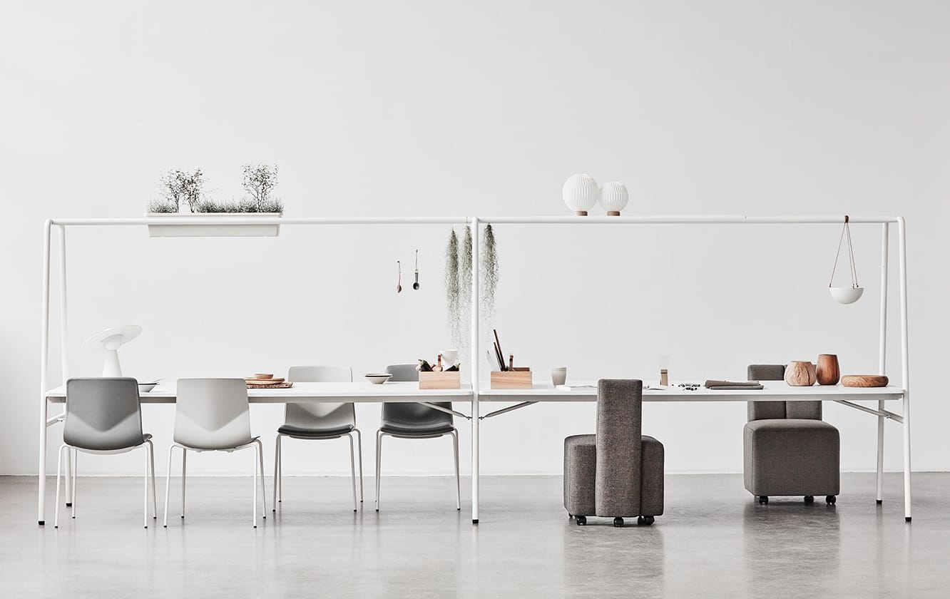 A group of chairs and tables in a white room.