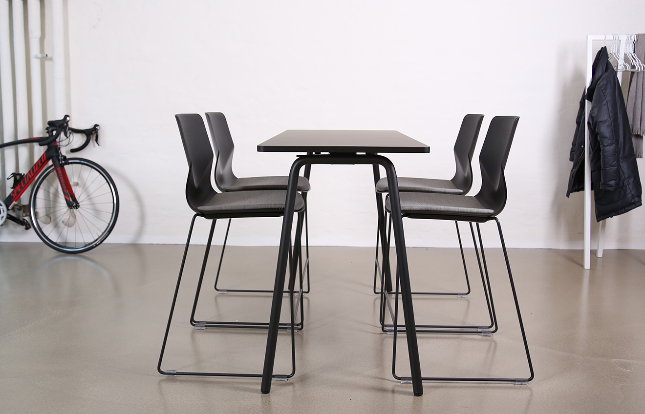 A white standing height tables and chairs