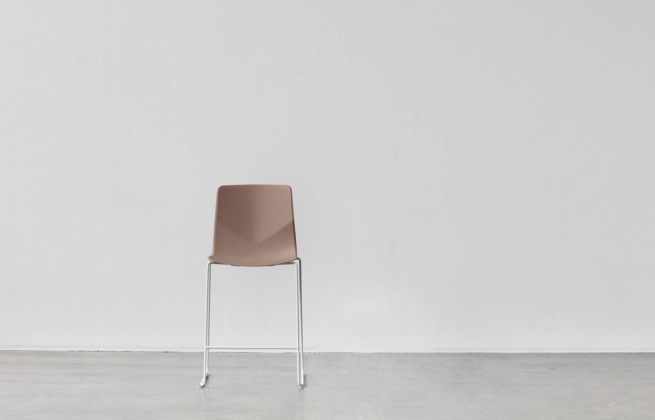 A chair in a white room against a wall.