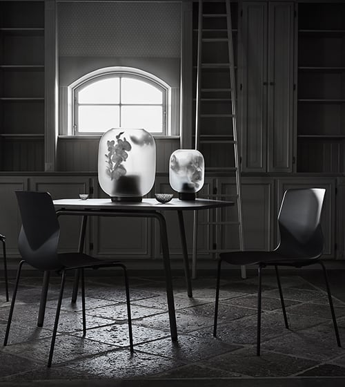 A black table and chairs in a dark room.