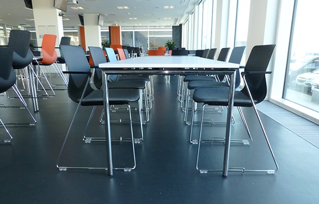 Conference standing height tables and chairs in a conference room.
