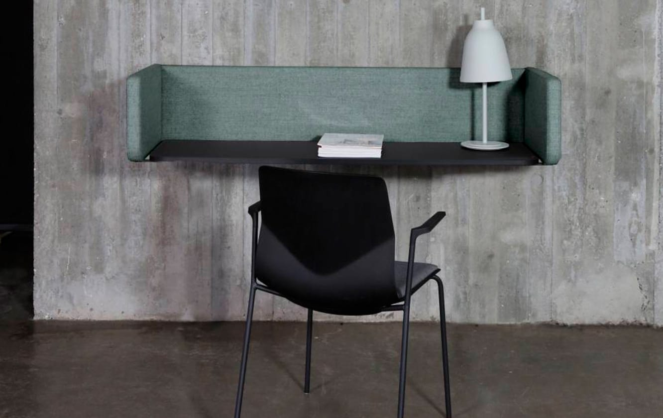 A chair and a wall mounted desk workstation