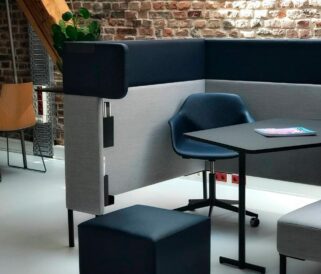 An office with a desk, chairs, and a wall.