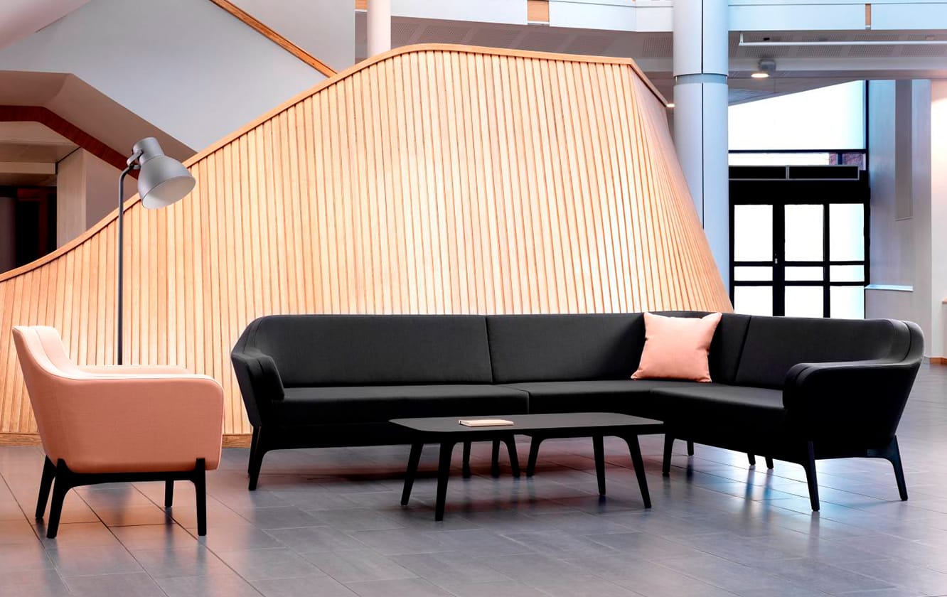 Black and pink office sofas and chairs in a lobby.