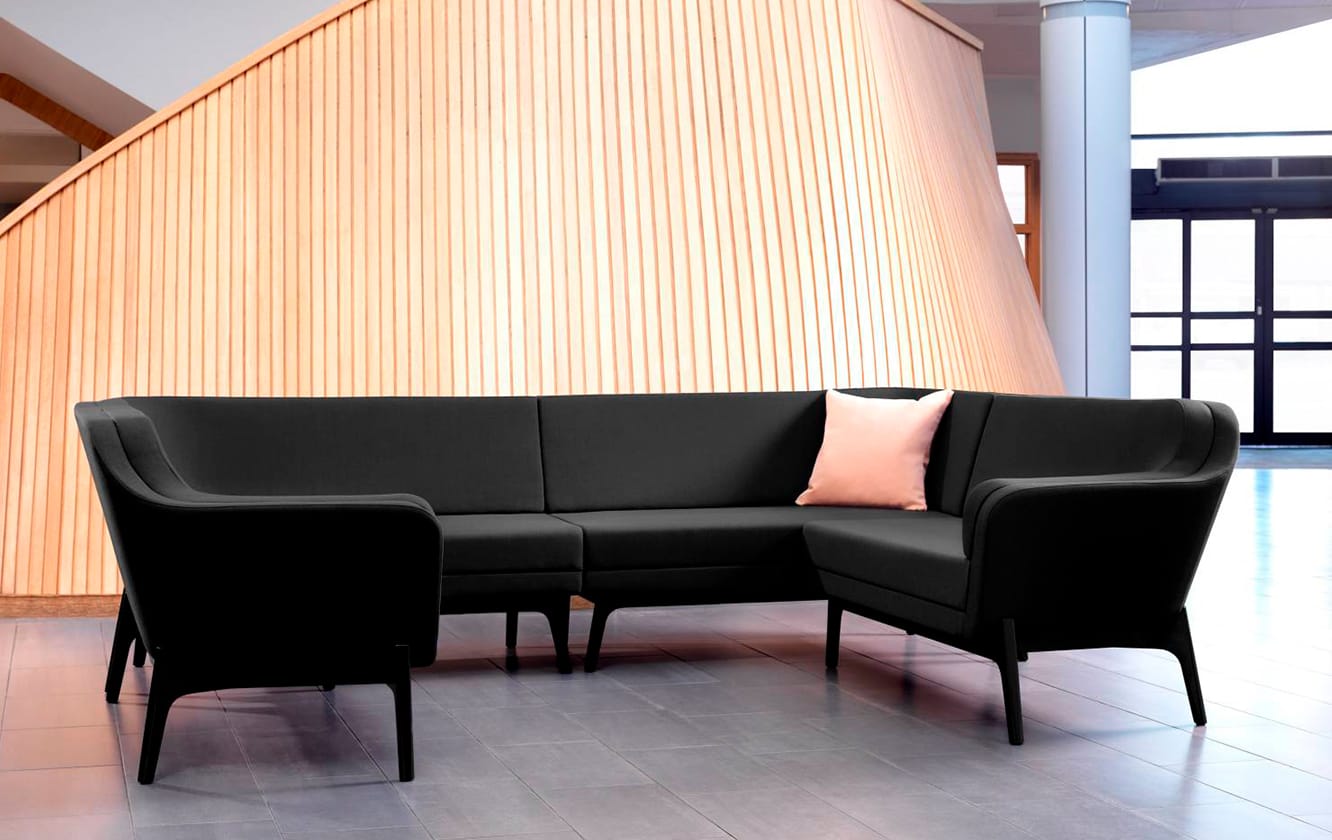 Black and pink office sofas and chairs in a lobby.