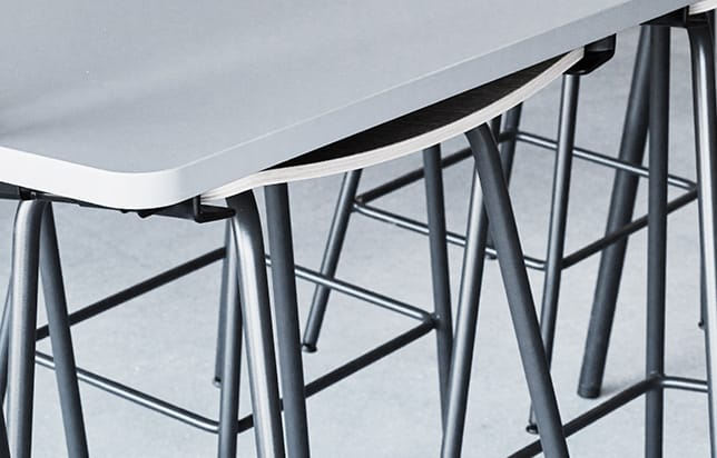 A close up of a table with metal legs.