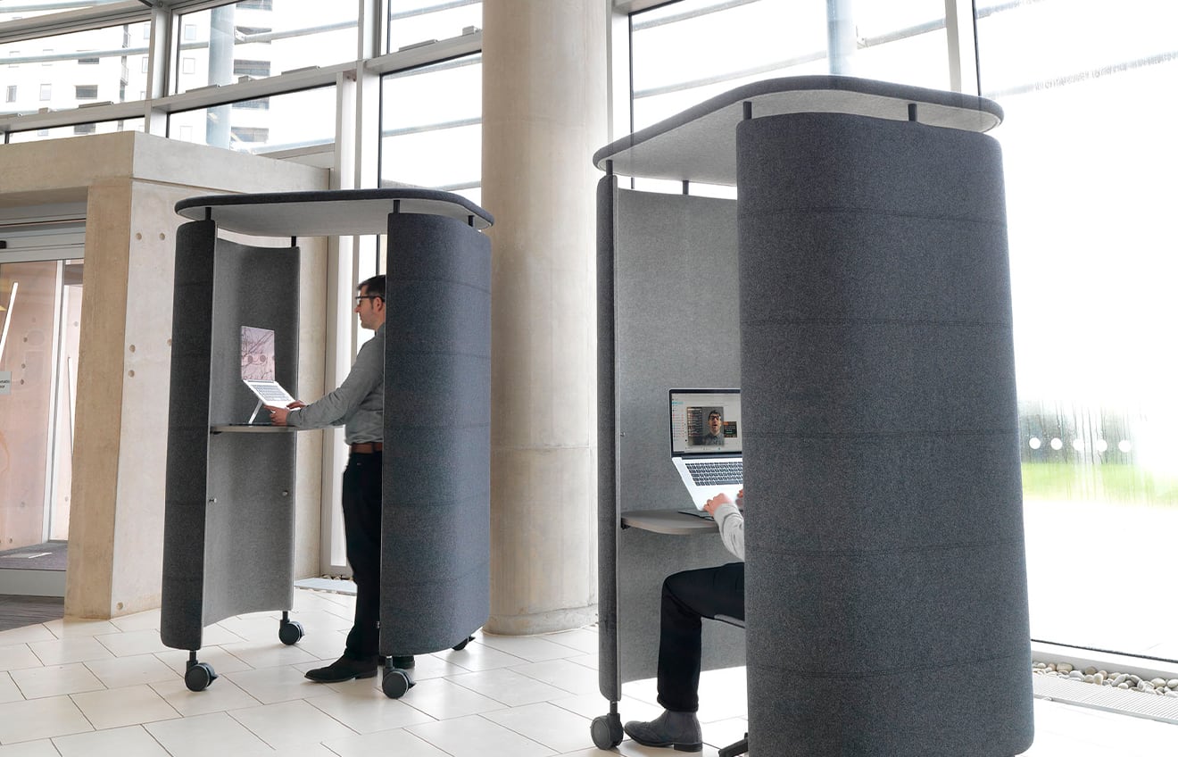 two blue office work booths in a reception area