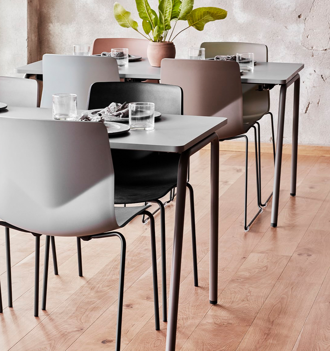 A group of canteen furniture including chairs and tables in a dining room.