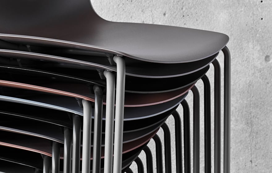 Stacked black plastic chairs