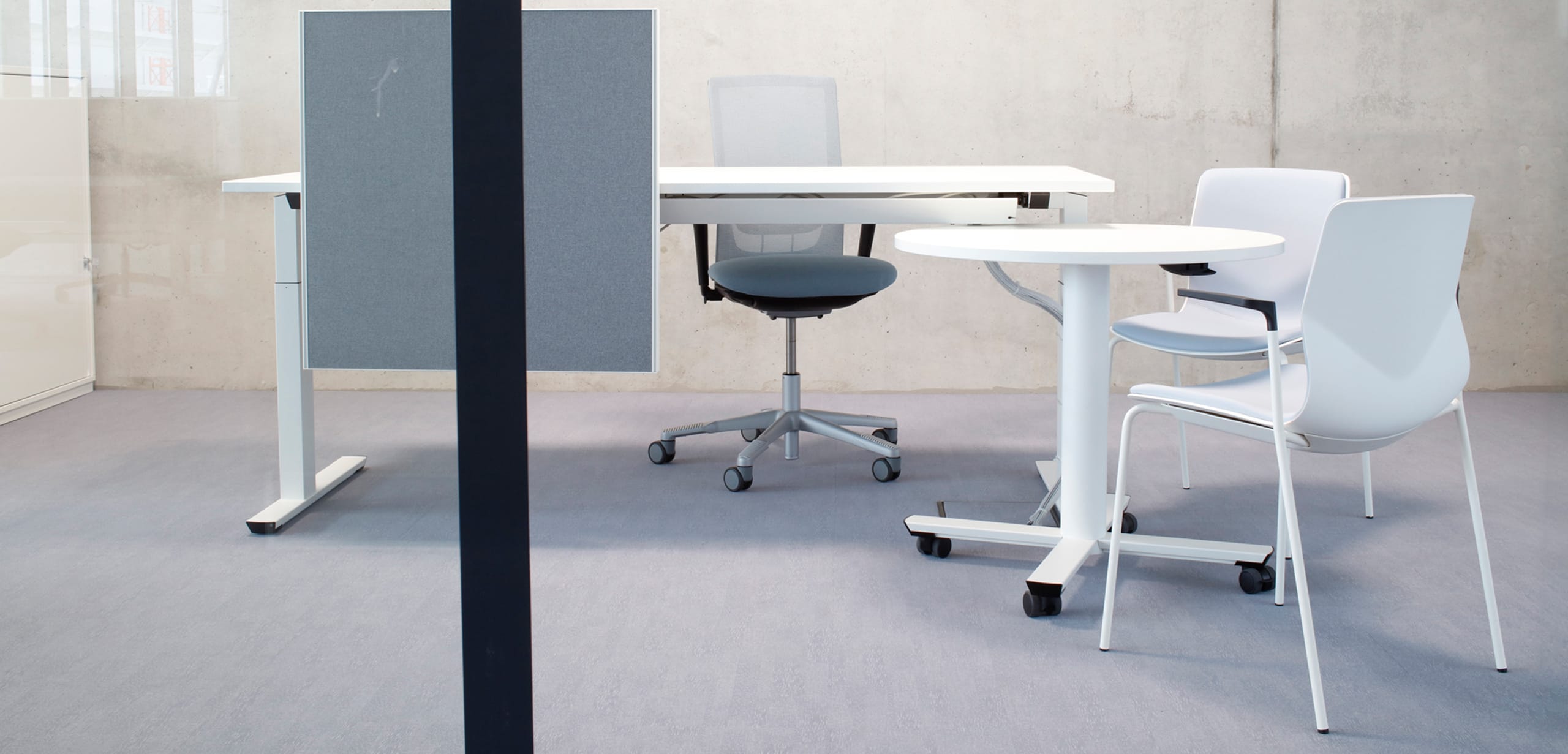 A white desk and chairs in an office.