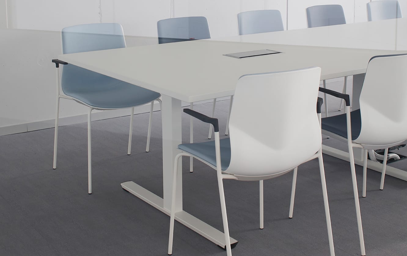 A group of office desk chairs and office tables in a lecture hall