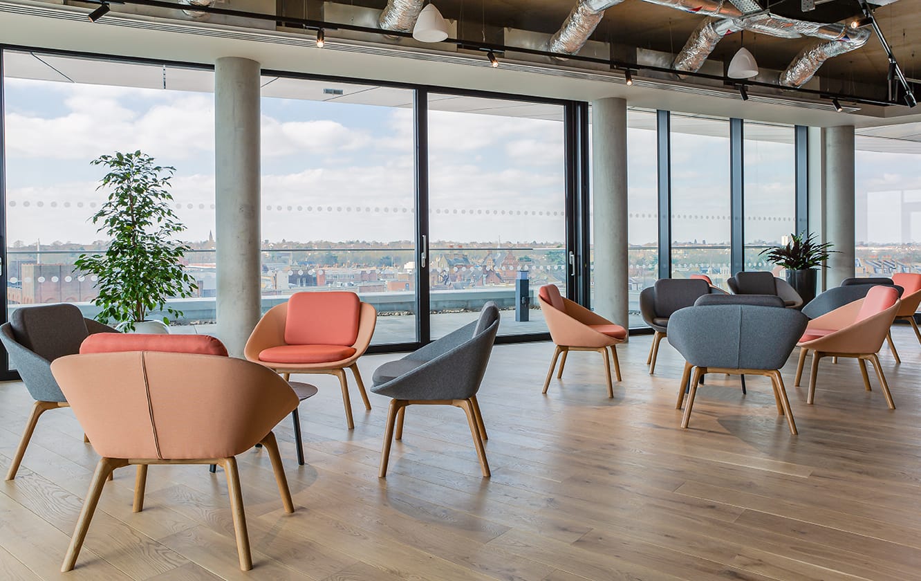 A group of lounge chairs for offices in an office with a view of the city.