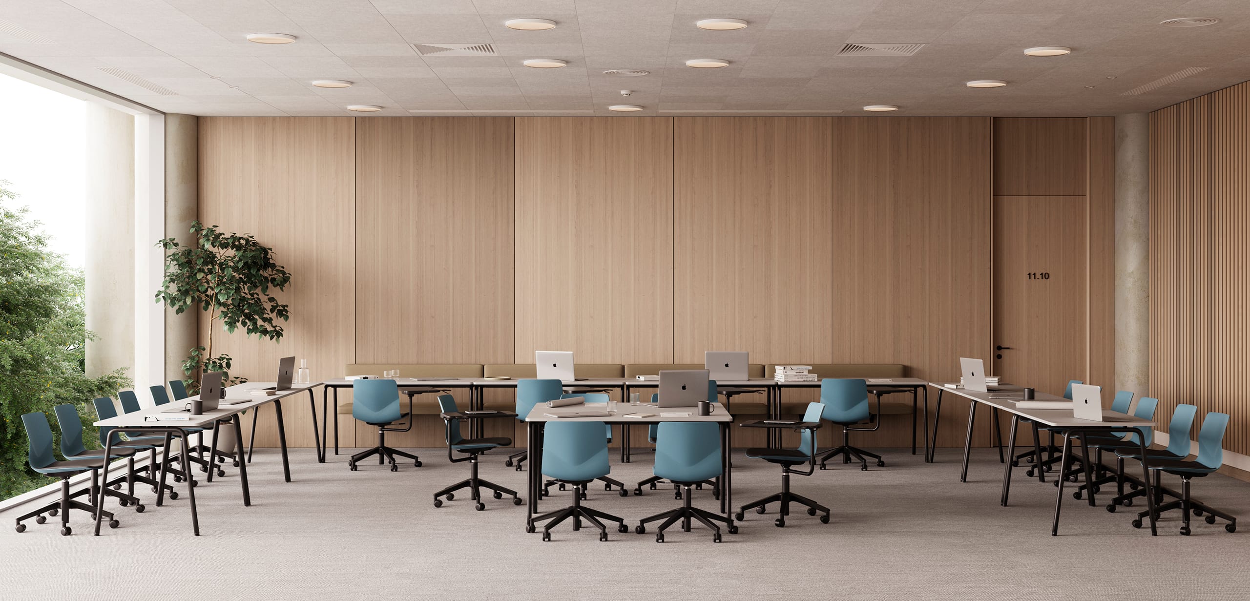 A room with blue office desk chairs, office tables and wooden walls.