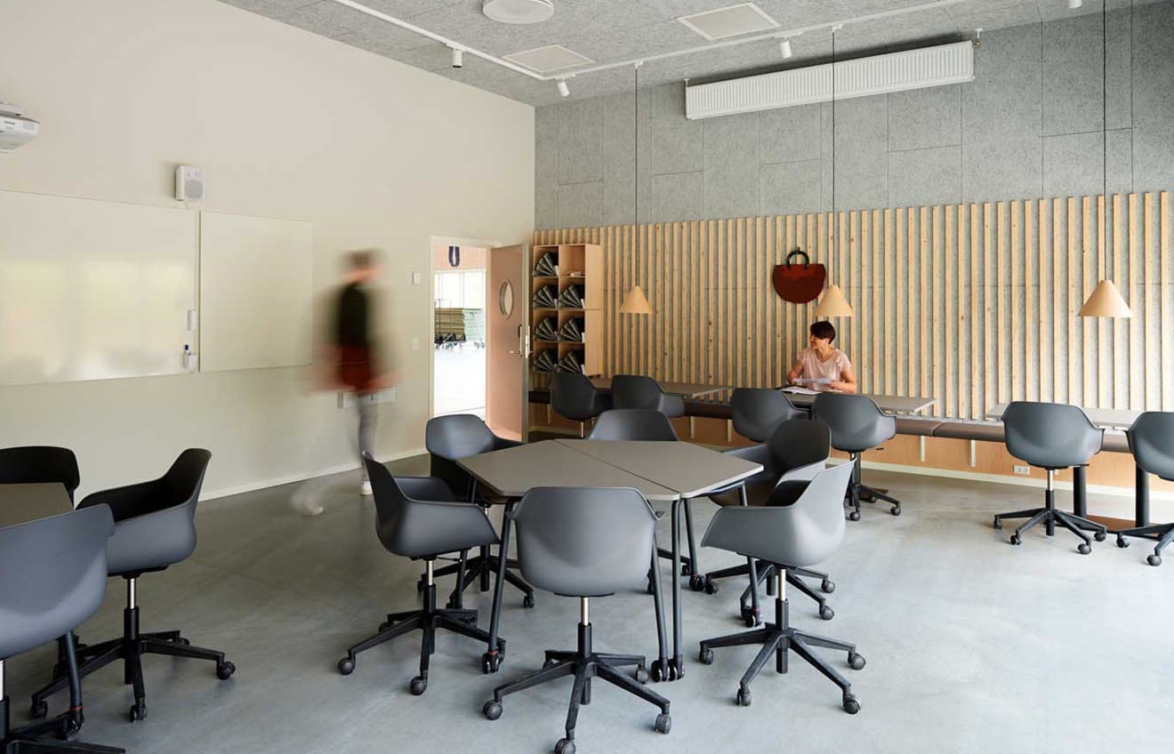 An office with tables and chairs in it.
