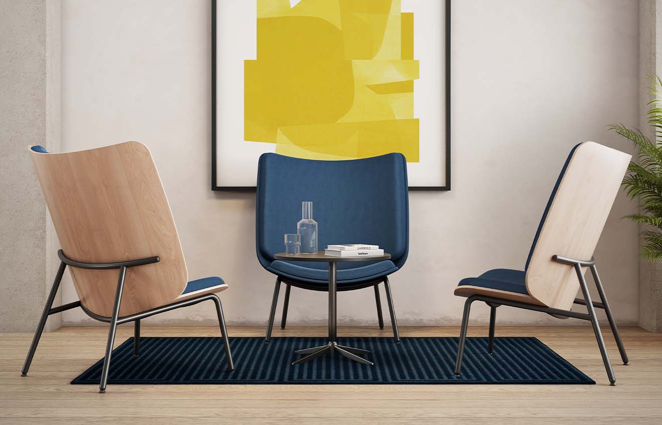 Three lounge chairs for offices in a room with a yellow painting.