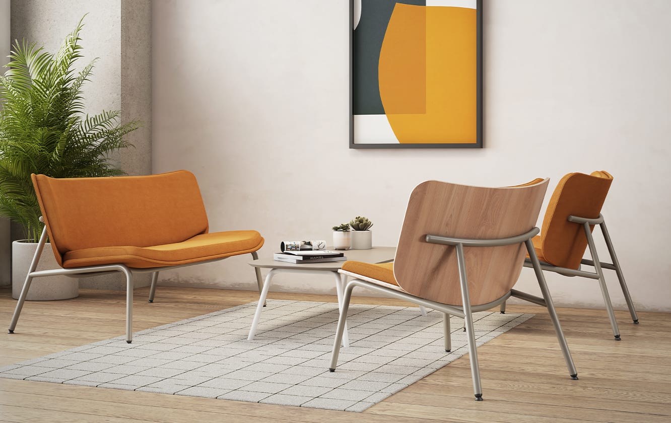 Three orange lounge chairs for offices in a room with a painting on the wall.