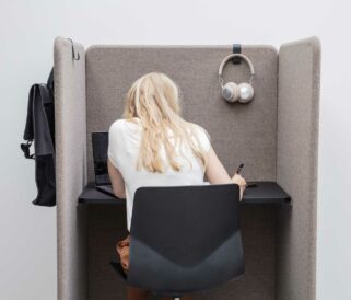 A woman sitting at a desk in a study booth