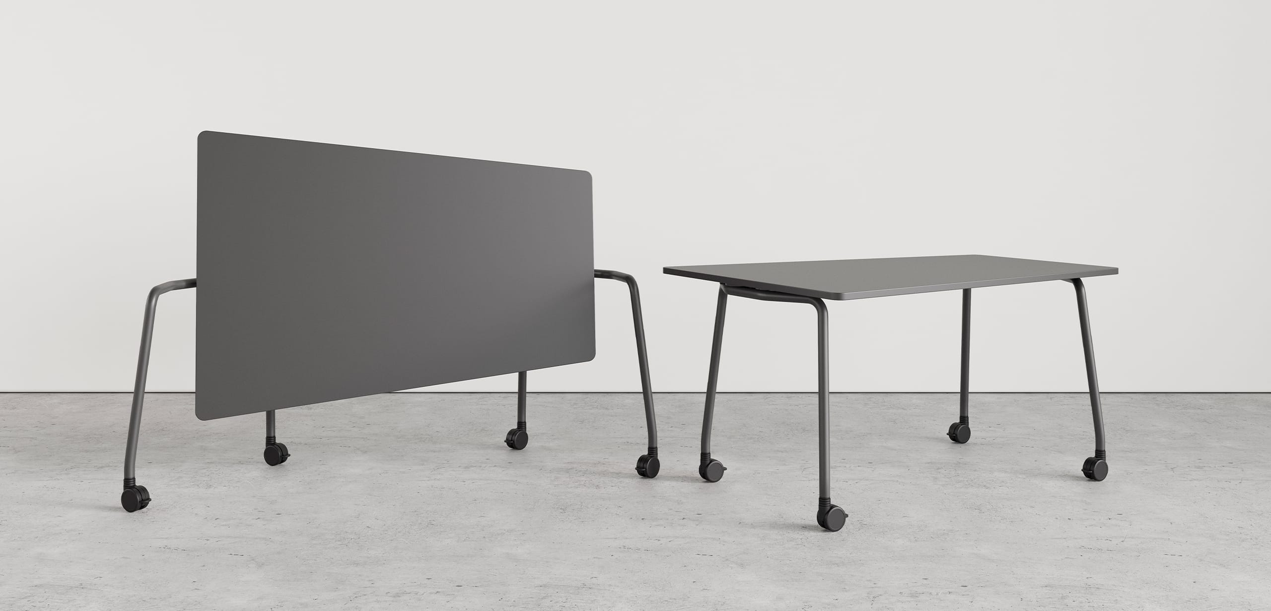 Two grey tables on wheels next to each other.