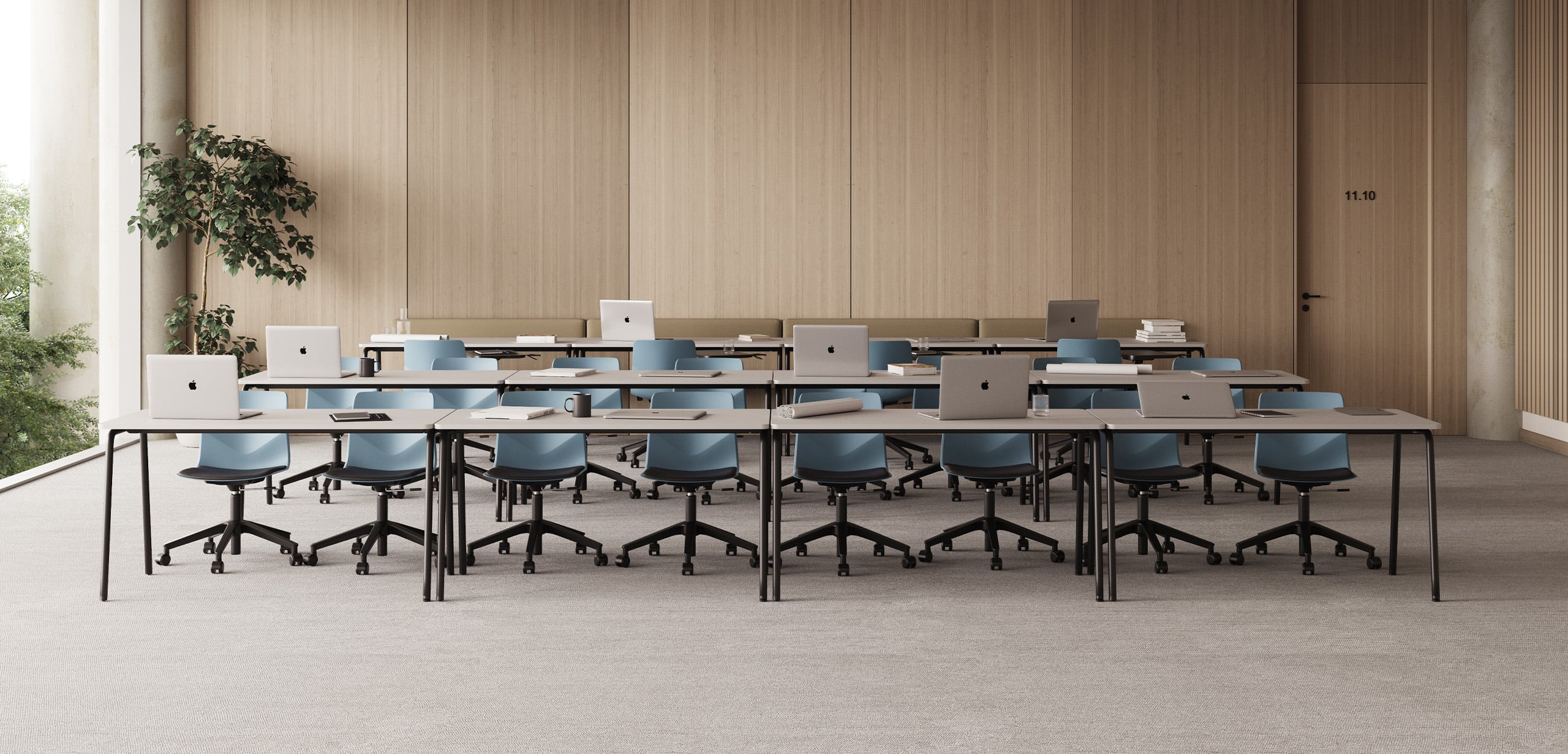 A classroom with blue office desk chairs and office desks.