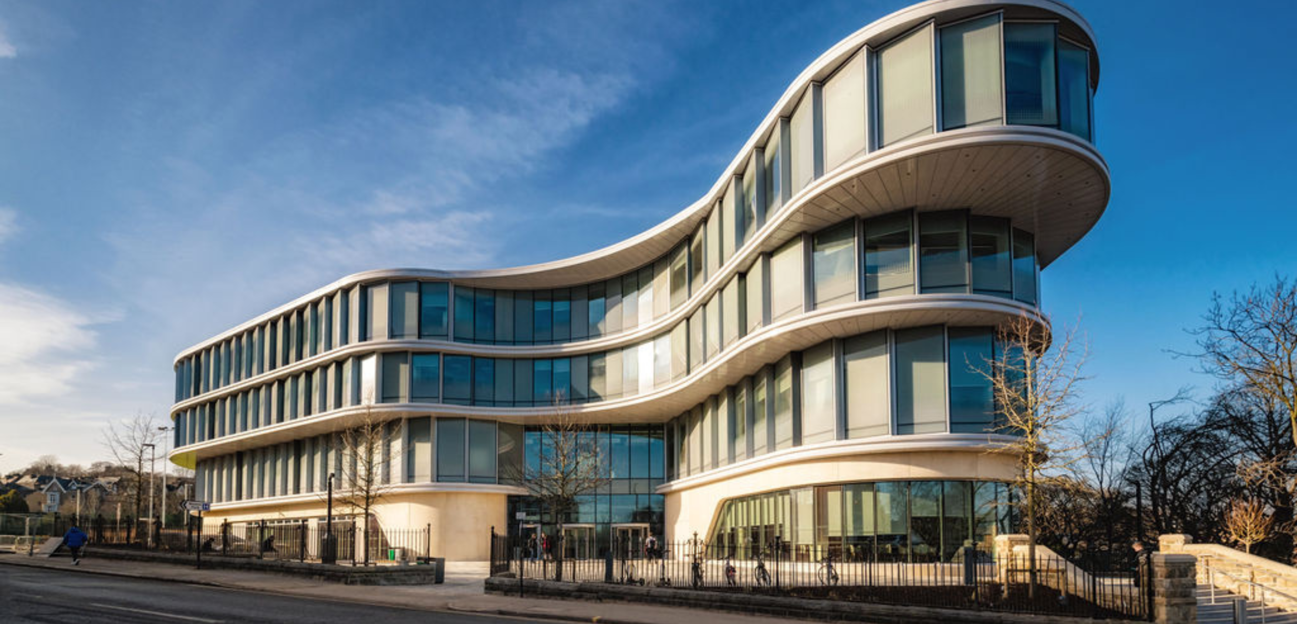 A modern office building with curved glass windows at the University of Sheffield