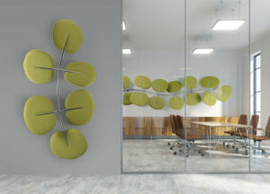 A modern office with green Botanica office acoustic solutions that look like leaves on the wall.