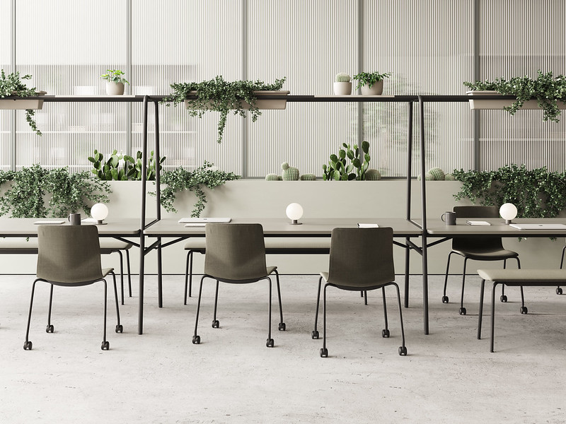 A dining room with FourReal A 2 1 community tables, chairs and plants.