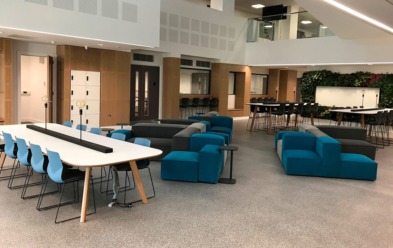 Brand identity through furniture at Coventry University. Blue chairs and soft seating.