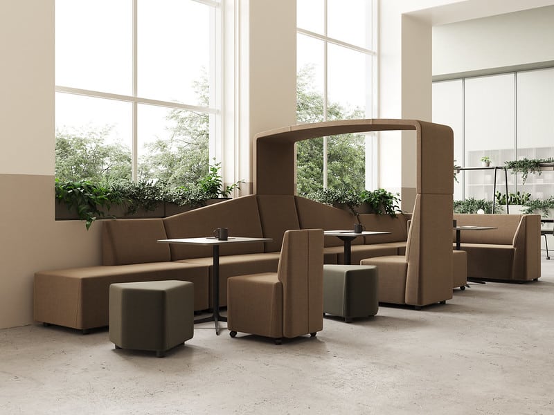 A lounge area with FourLikes office furniture including couches and chairs in a modern office.