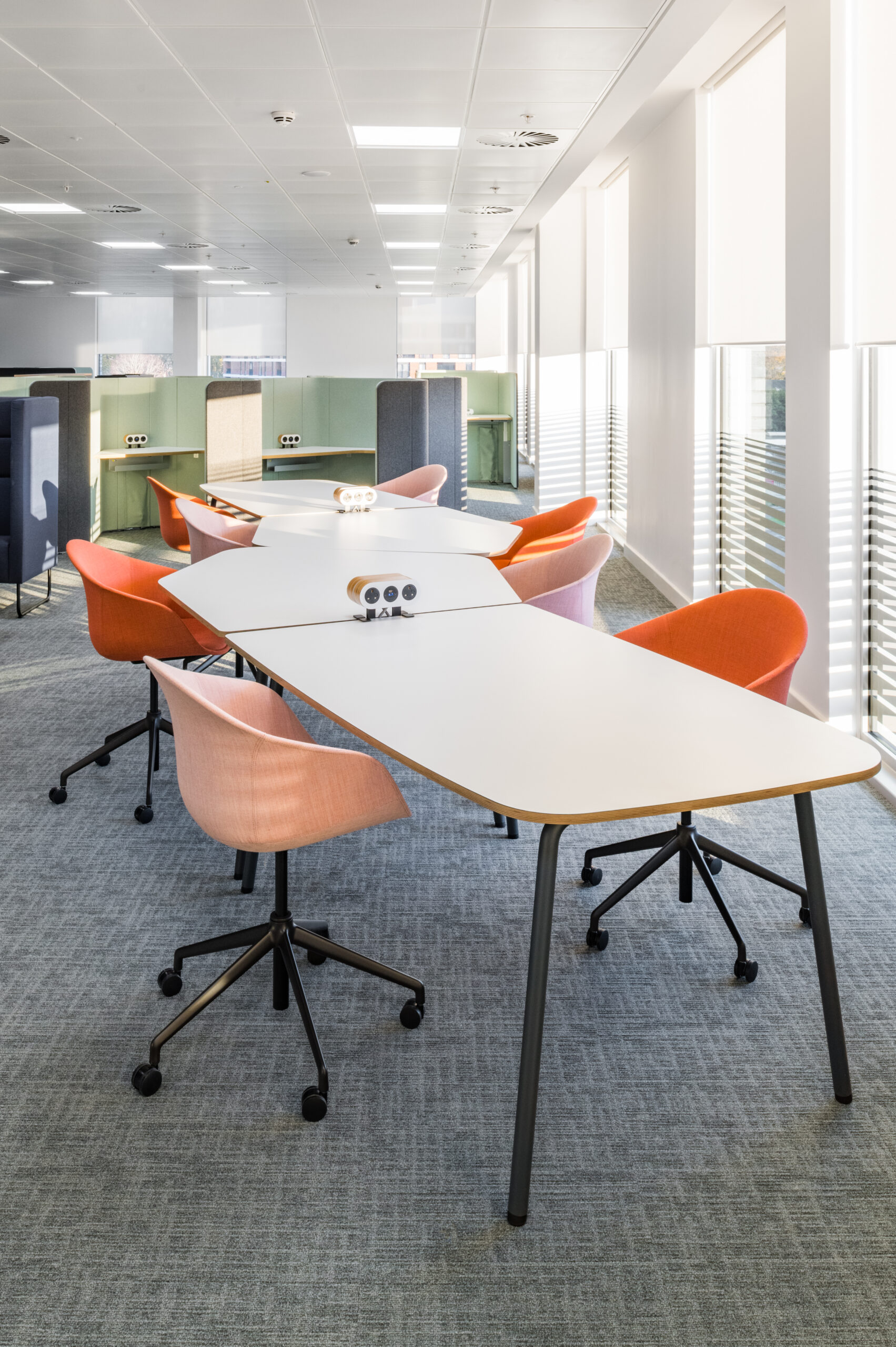 An office with Ocee and Four Design orange desk chairs and a white table in Crawley Council Town Hall.