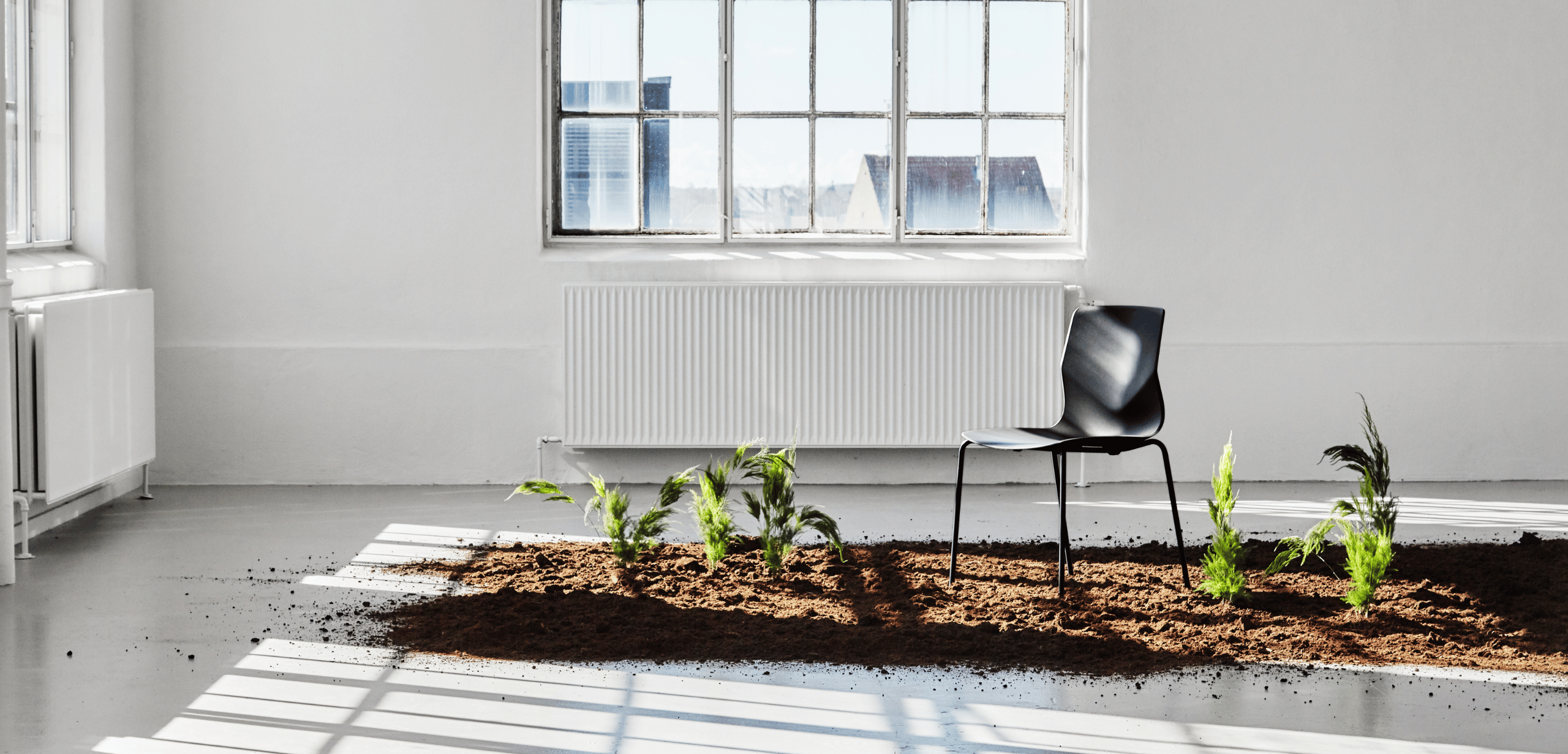 A chair in the dirt next to a window.
