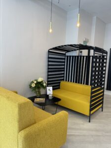 Office sofas with a yellow couch and a black canopy.