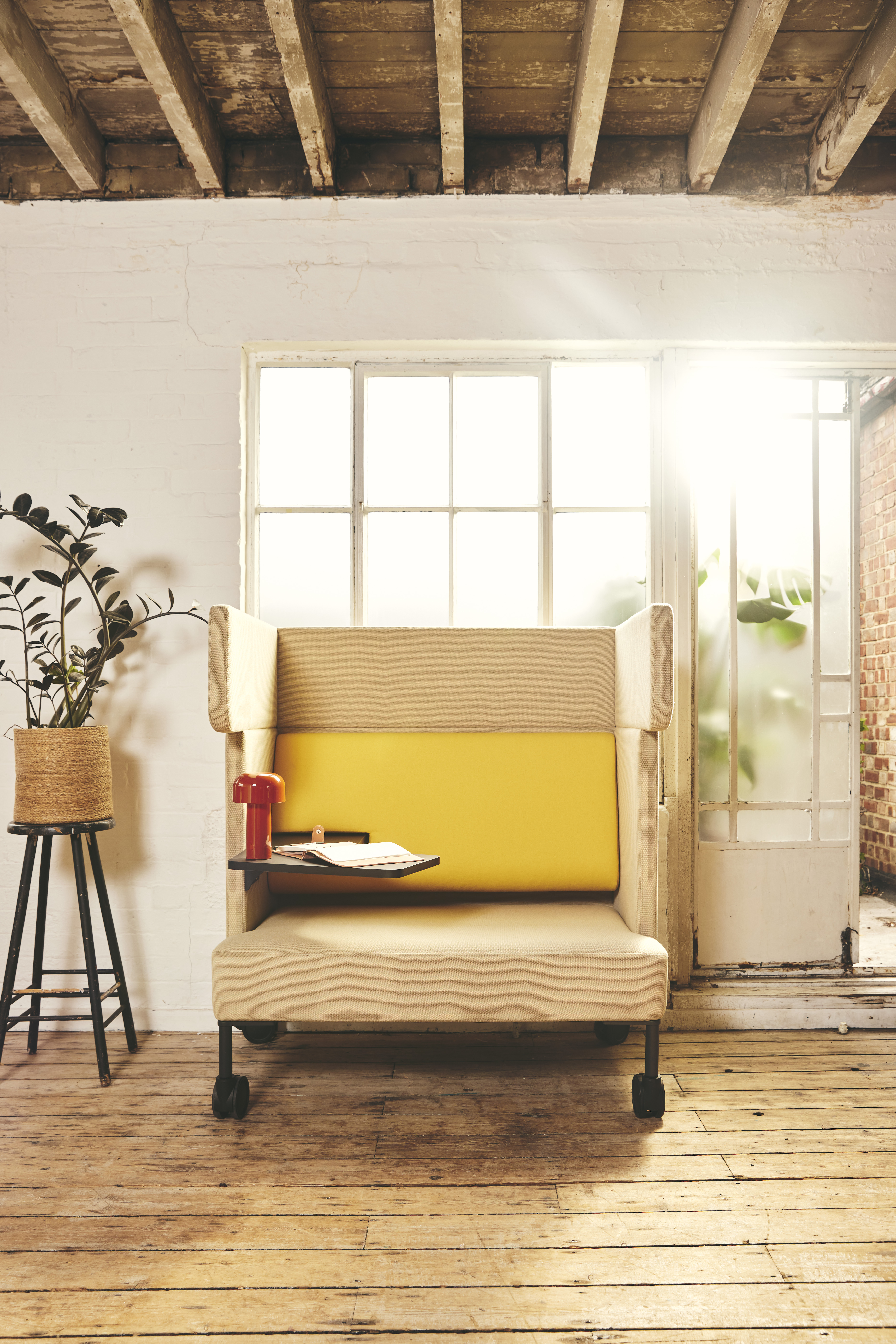 FourUs Solo yellow office sofas in a room with wooden floors.