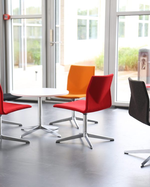 A group of colourful chairs in a conference room.