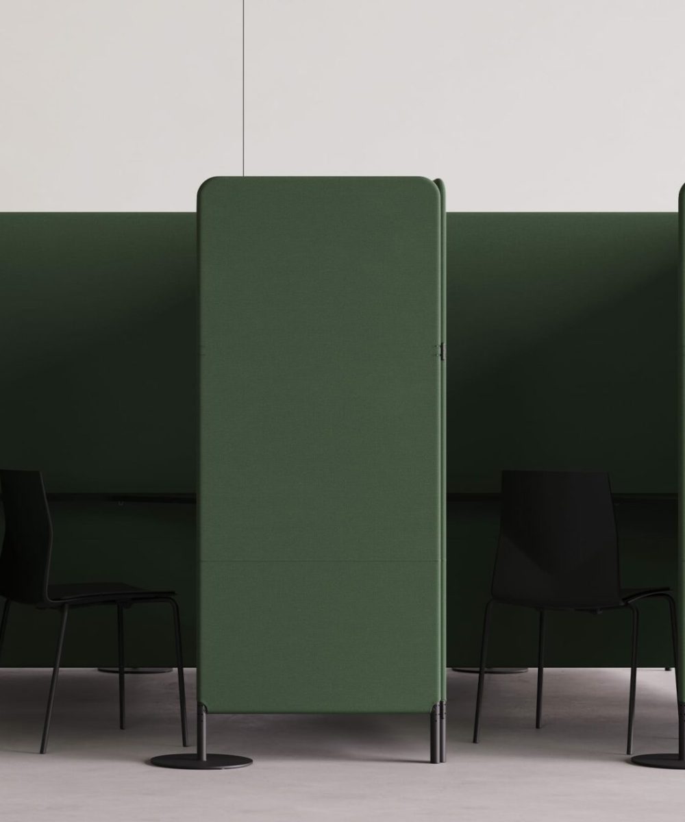 A green FourPeople office work booth and office cubicle with two chairs and a desk.