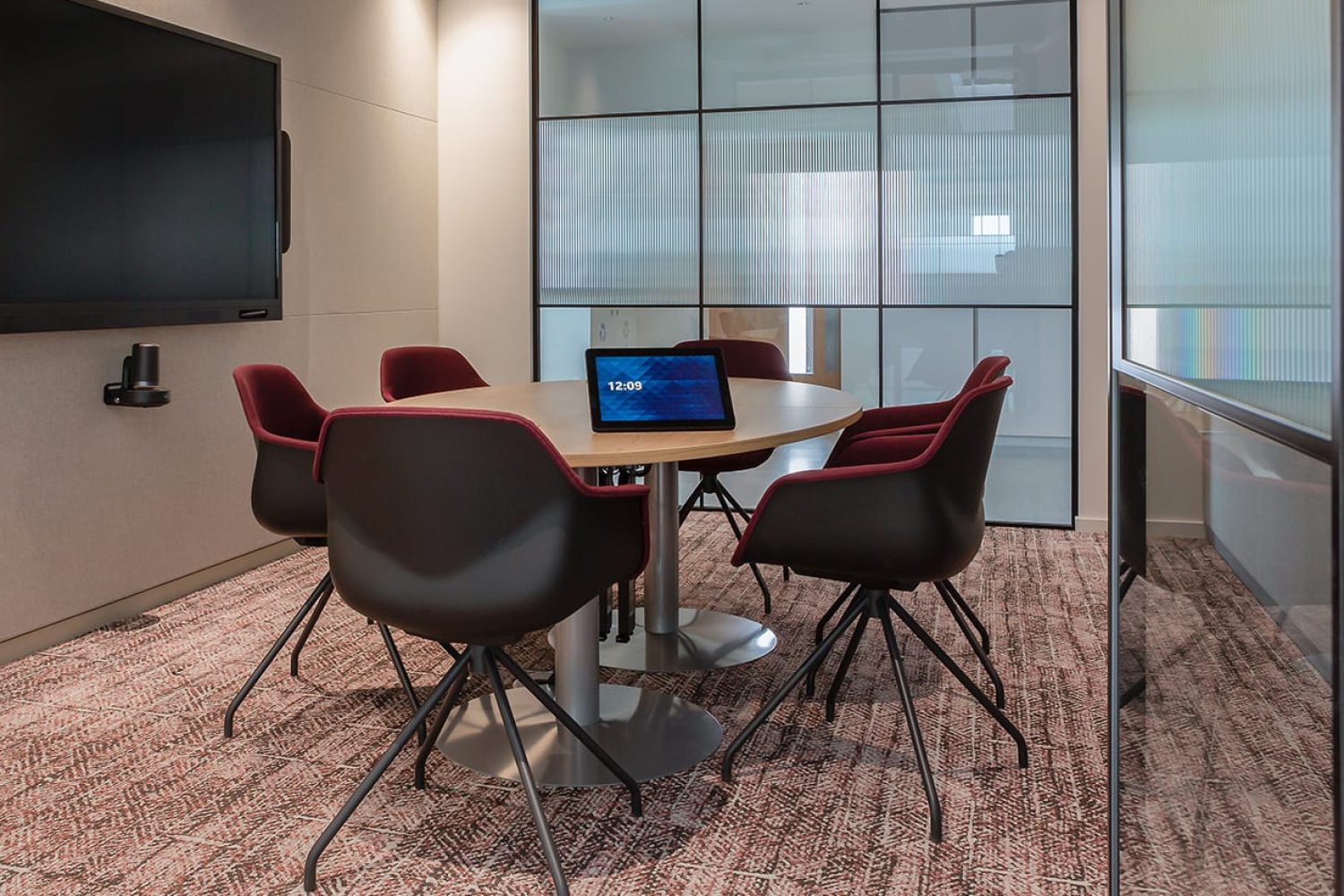 A conference room with a large table and office desk chairs.