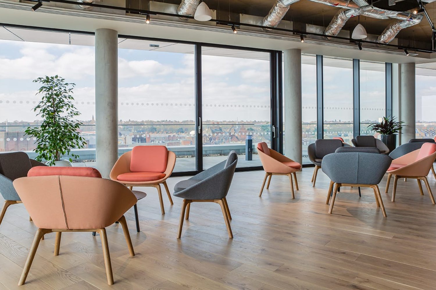 A group of lounge chairs for offices in an office with a view of the city.