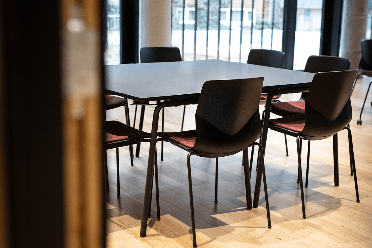 Canteen furniture including black table and chairs in a dining room.