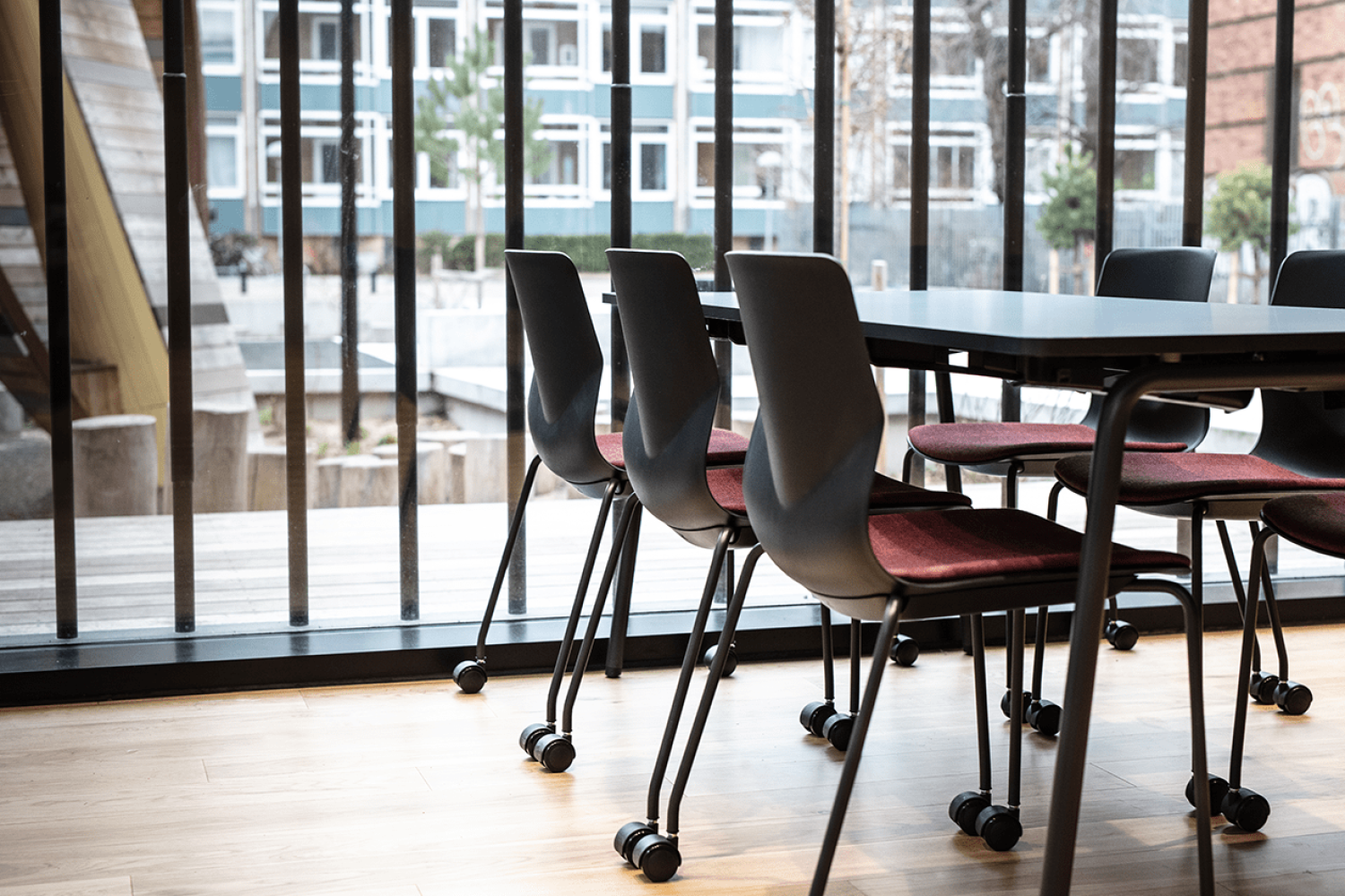 Canteen furniture including black table and chairs in a dining room.