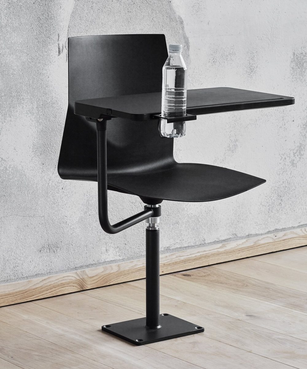 A black chair with a bottle of water on it.