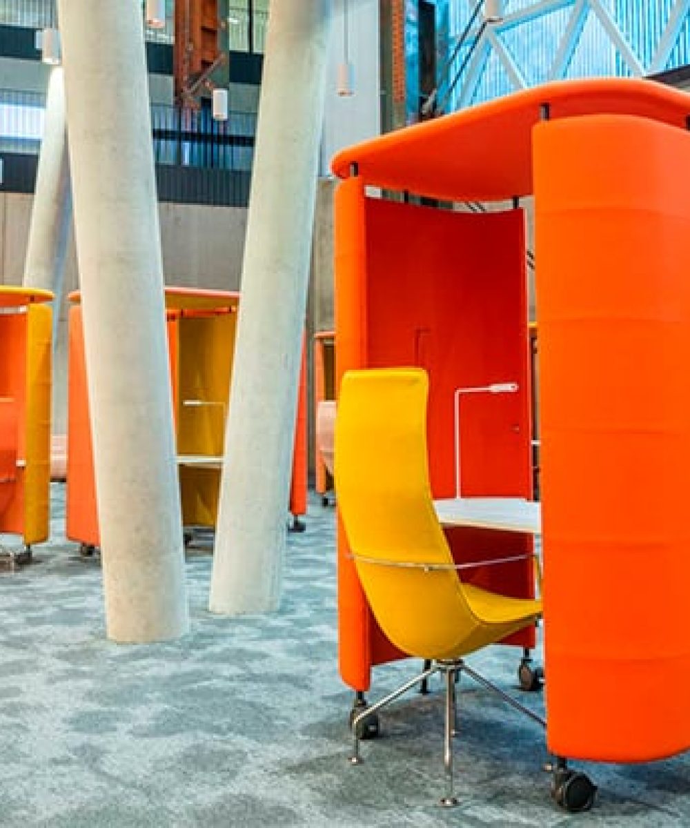 orange and yellow office work booths in an antrium